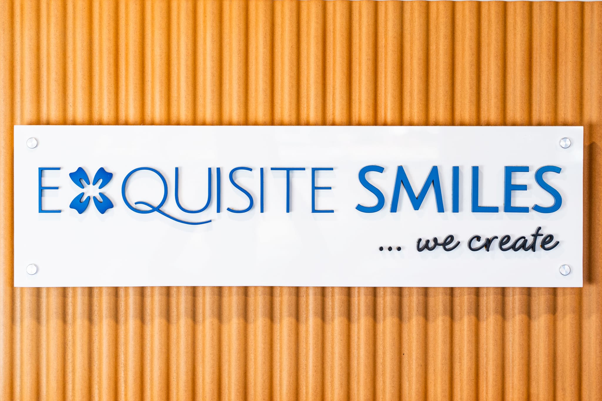 Exquisite Smiles Warner dental clinic signage on interior wall