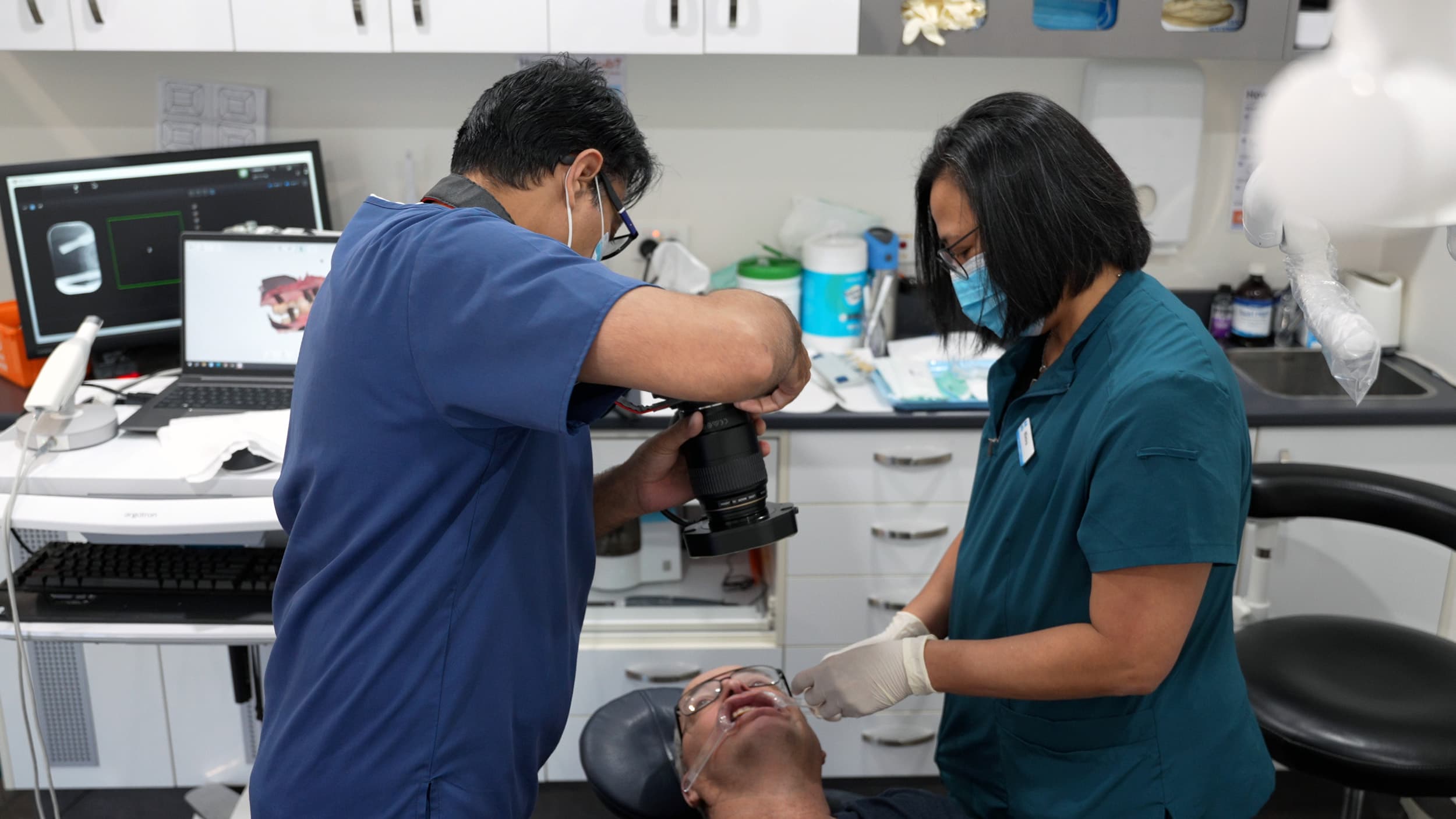 Dentist capturing clinical photos during patient dental assessment