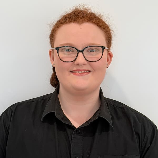 Claire, friendly front desk coordinator welcoming patients at Exquisite Smiles Warner