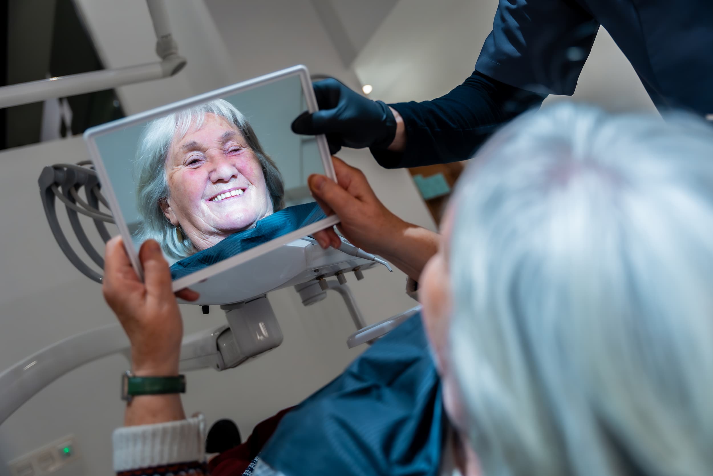 Elderly patient viewing smile after all on x implants