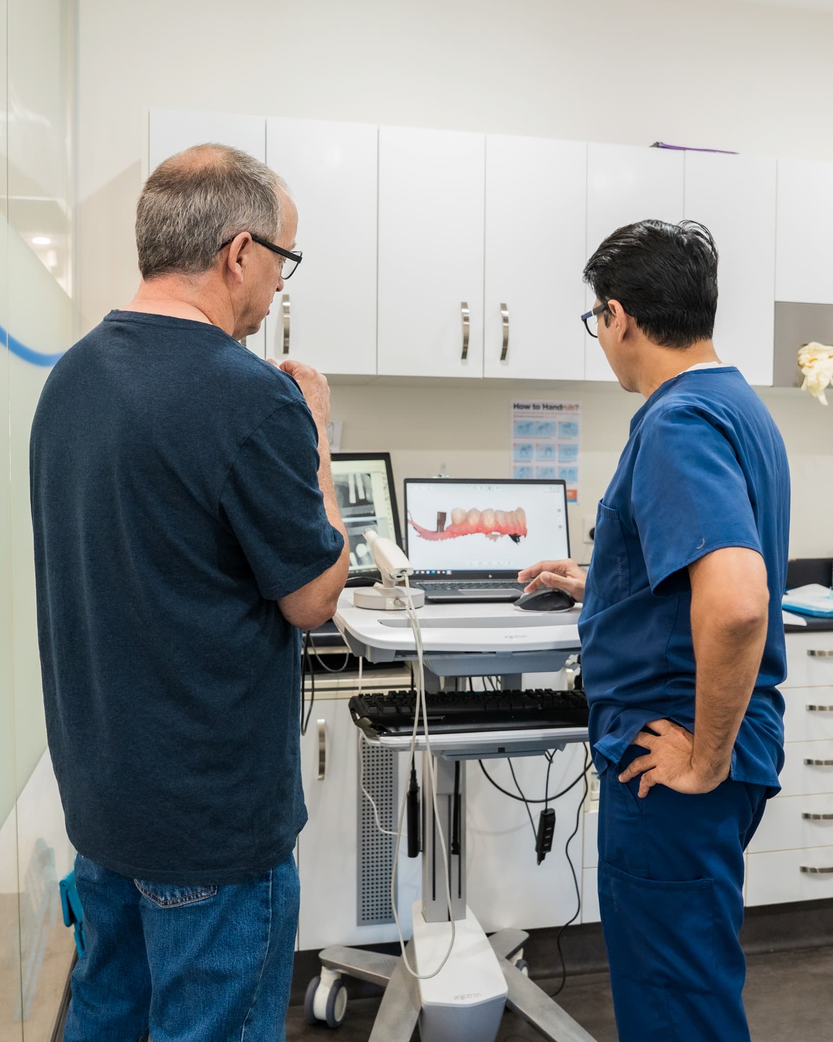 Dentist explaining a digital 3D treatment plan to a patient during an oral health consultation.